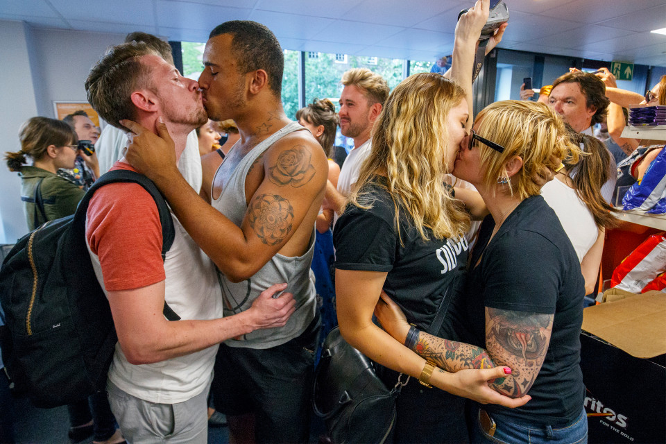 © Licensed to London News Pictures. 13/08/2016. London, UK. Gay couples stage a big kiss in protest at Sainsbury's in Hackney, east London on Saturday, 13 August 2016. Protest is as a reaction to a security guard in Sainsbury's on Hackney Road allegedly told a shopper that holding hands with his boyfriend was 'inappropriate' on Monday. Photo credit: Tolga Akmen/LNP